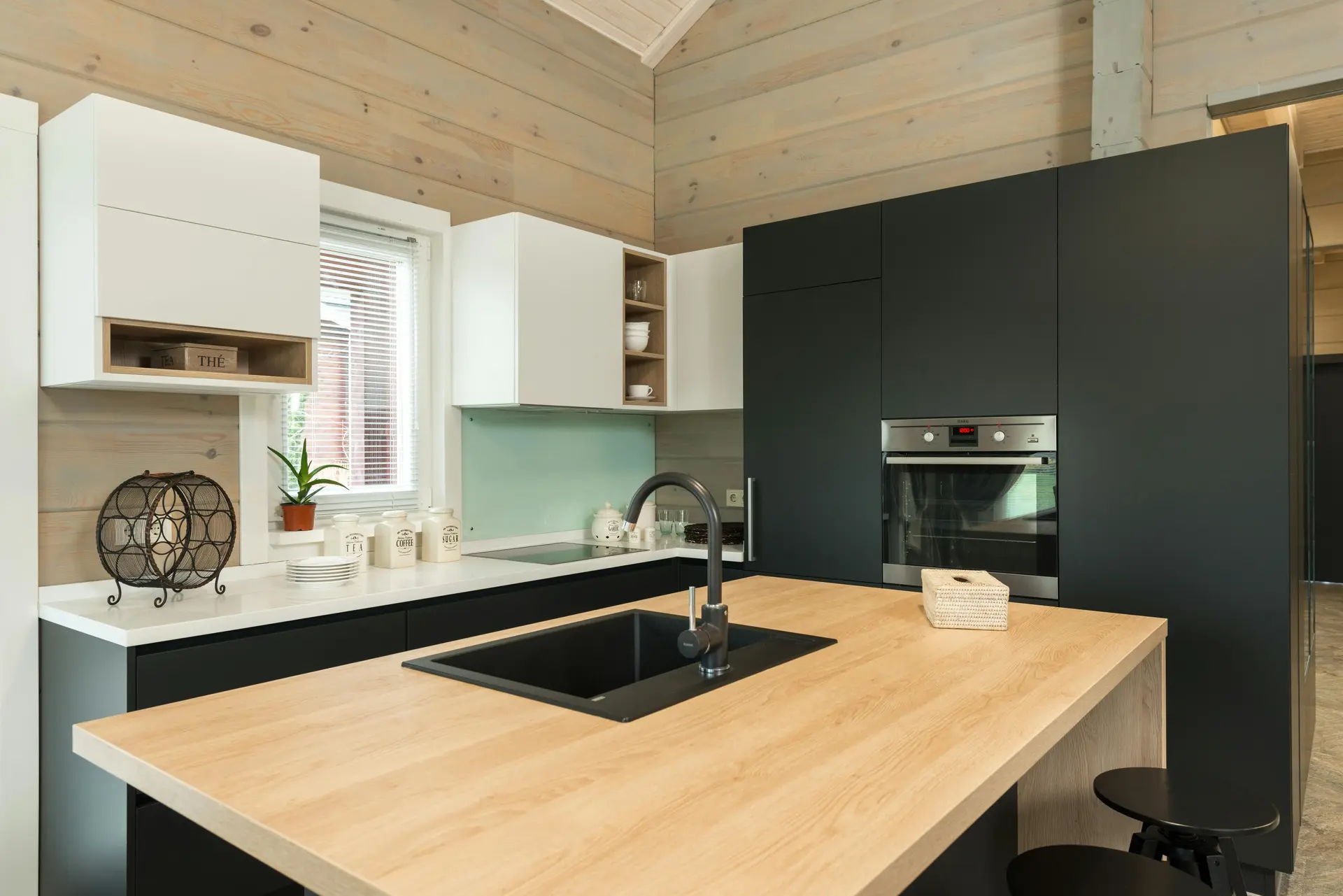 Modern kitchen with dark millwork and stone countertops